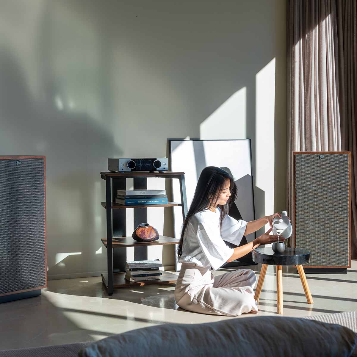Onkyo Muse Y-50 Network Integrated Amplifier - Silver - lifestyle view of unit on shelf to left with seated woman to right