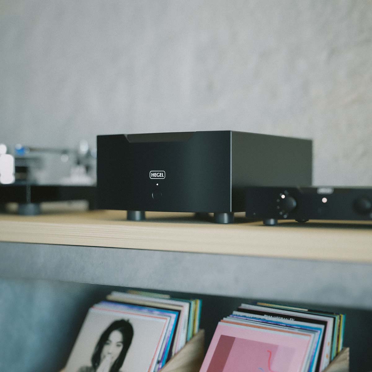 Hegel H30A 1-Channel Power Amplifier close-up lifestyle shot of unit on shelf angled left
