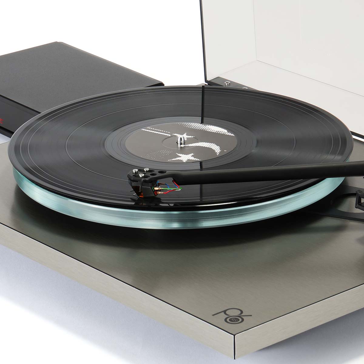 Rega Planar 6 RS Special Edition Turntable - high-angle close-up three-quarter view with open dustcover and record on platter with tone arm engaged