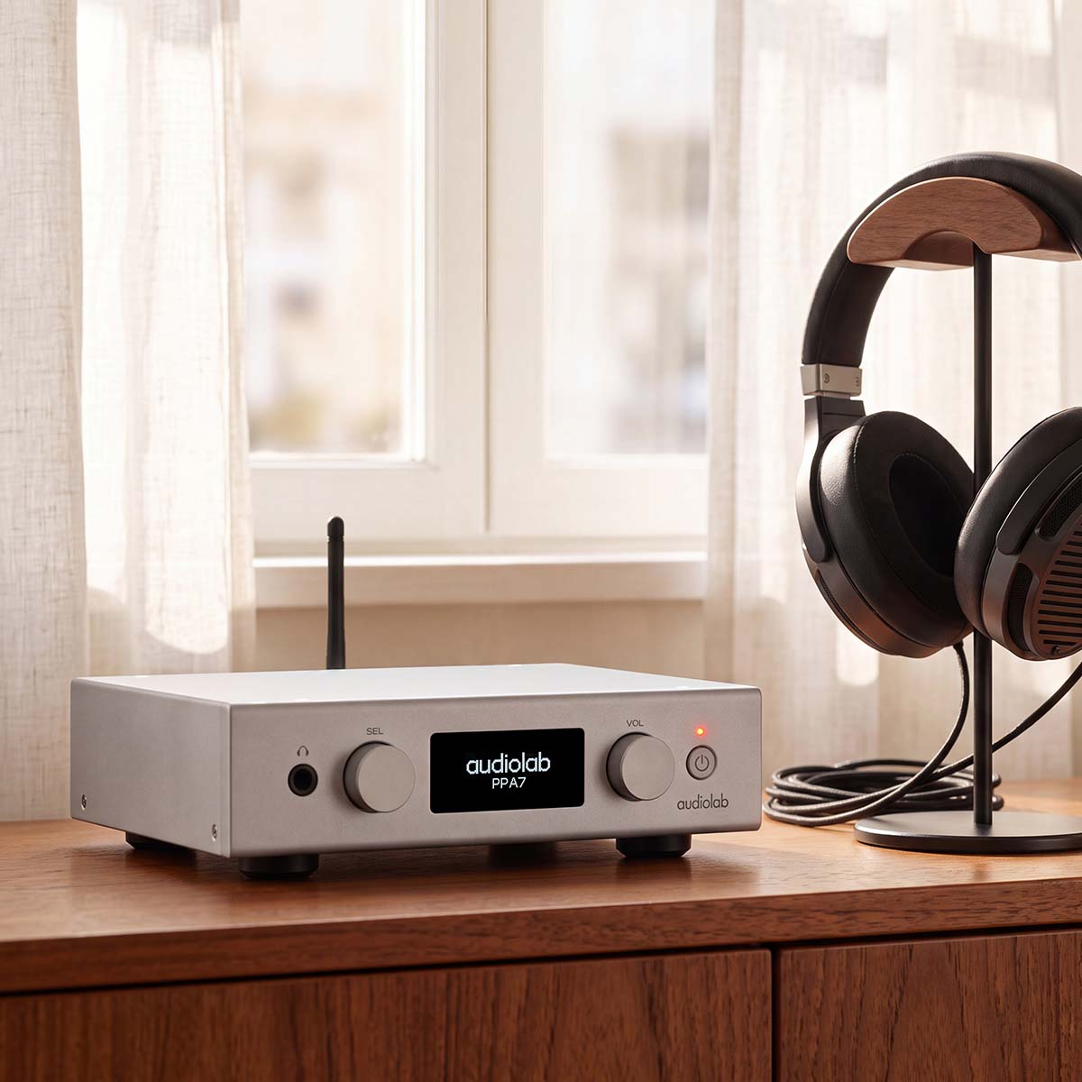 Audiolab PPA7 Phono Preamplifier - Silver - lifestyle photo of unit on cabinet to left of headphones on stand