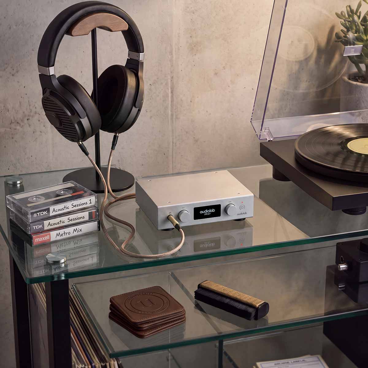 Audiolab PPA7 Phono Preamplifier - Silver - lifestyle photo of unit on glass shelves to right of turntable