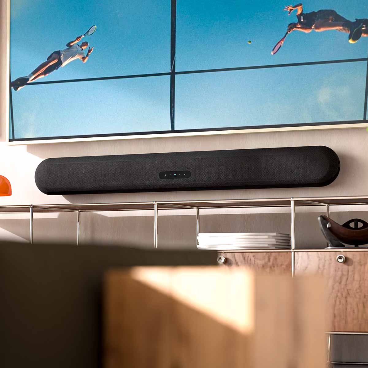 Bluesound Pulse Cinema Multi-Room Streaming Soundbar lifestyle photo of unit wall mounted under TV