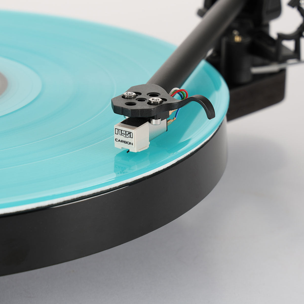 Rega Replay Turntable - detail of tonearm engaged over blue record