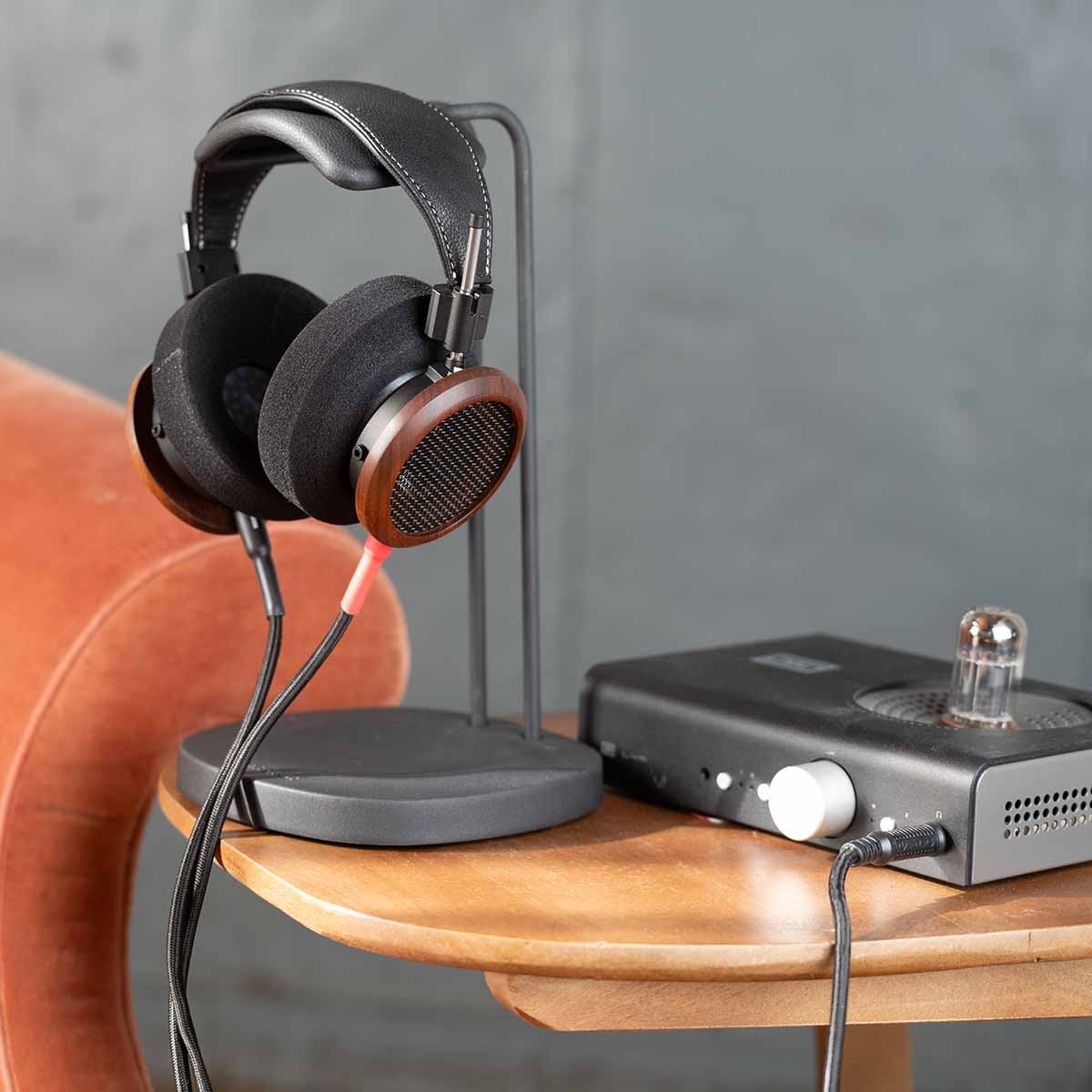 Grado Signature S950 Headphone - lifestyle shot front view on headphone stand next to headphone amp on table