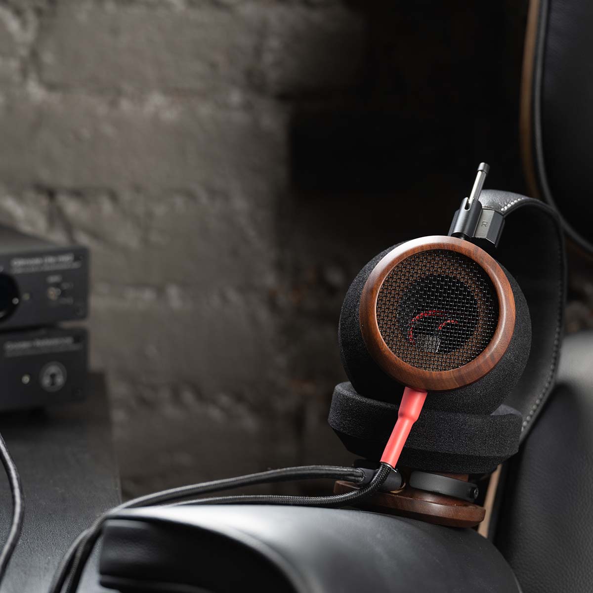 Grado Signature S950 Headphone - lifestyle shot unit laying on left earphone on a chair