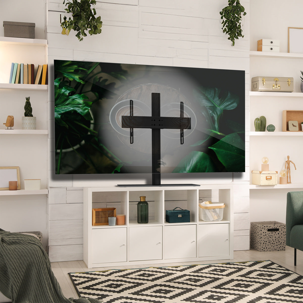 Modern living room with a TV mounted on a white wall, surrounded by decorative items.