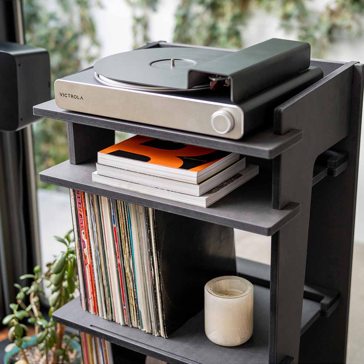 Victrola Stream Carbon Wi-Fi Streaming Turntable - black and silver - lifestyle shot front view of unit on top of record cabinet