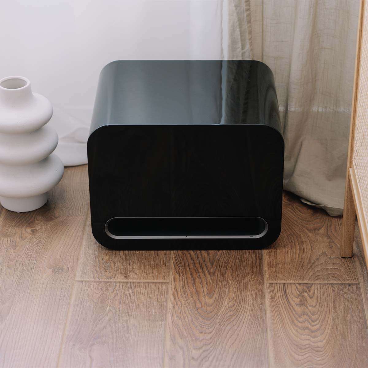 WiiM Sub Pro Wireless Smart Subwoofer - gloss black - lifestyle image