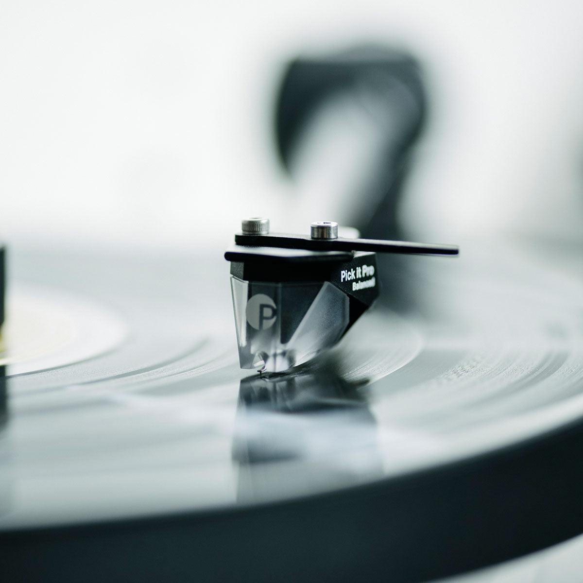 Pro-Ject XA B Balanced Acrylic Turntable - lifestyle shot close-up of phono cartridge with record and tone arm engaged