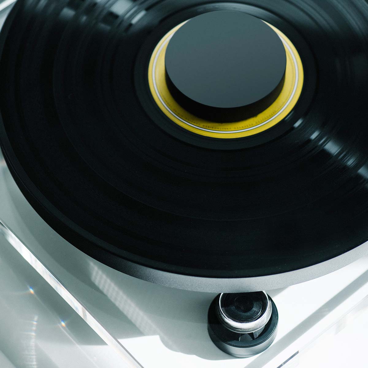 Pro-Ject XA B Balanced Acrylic Turntable - lifestyle shot top-down view of record and record puck on the platter and belt motor to bottom