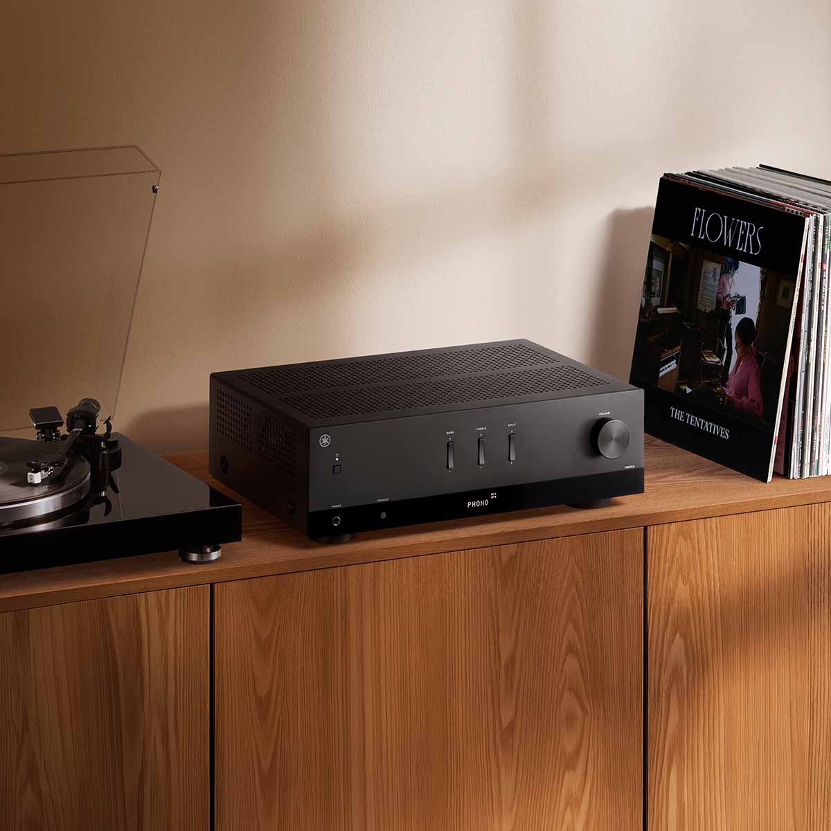 Yamaha R200A 2-Channel Hi-Fi Stereo Receiver with Bluetooth - Black - lifestyle photo of unit on cabinet between record player and records