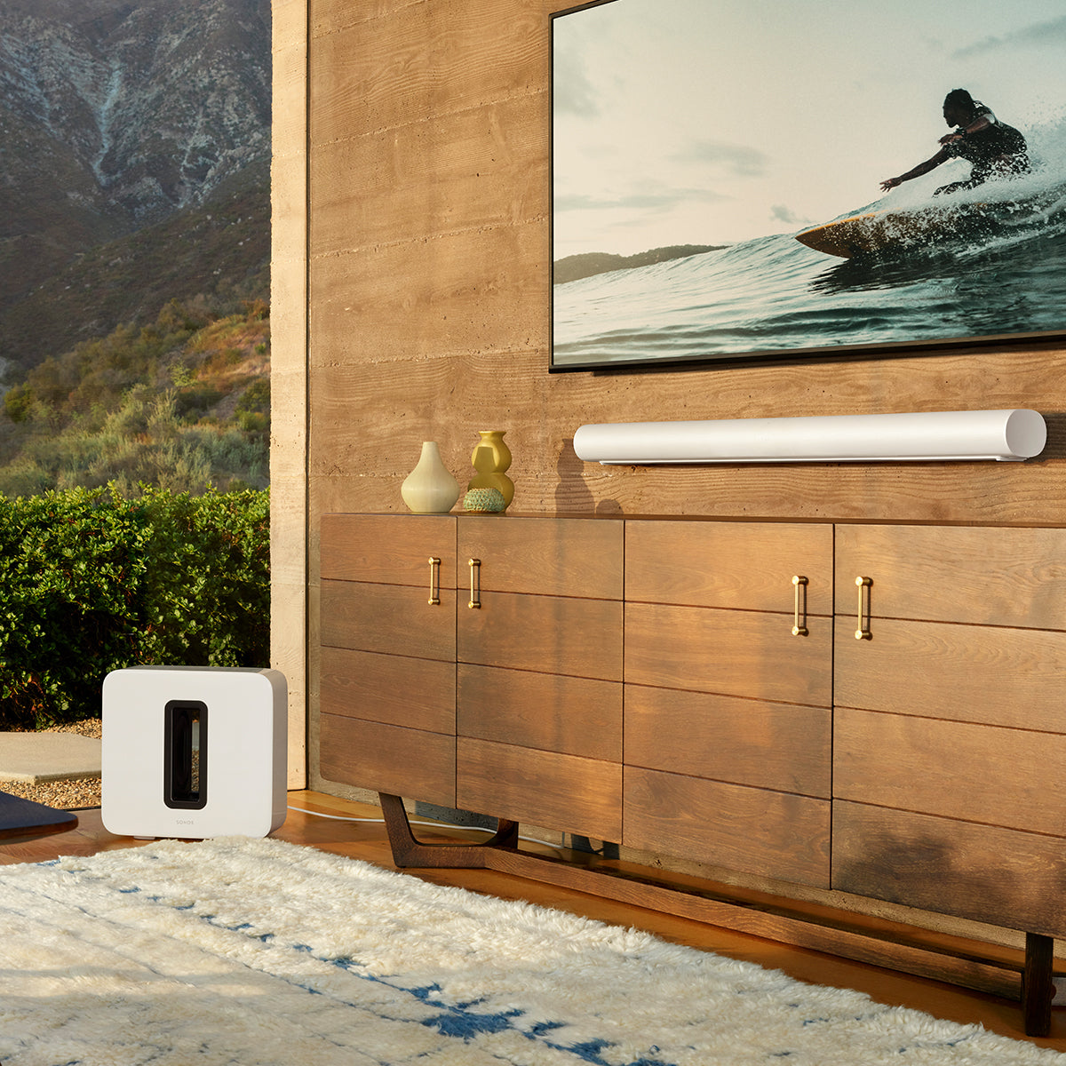 Sonos Arc soundbar in white mounted on a wall below a flat screen televsion