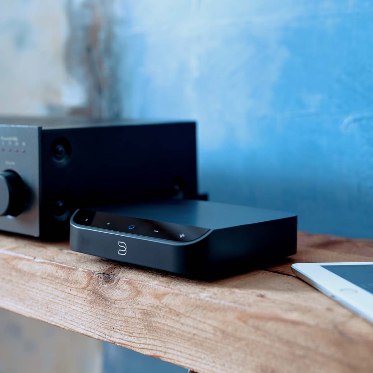 Bluesound NODE NANO Wireless Music Streamer on wood table