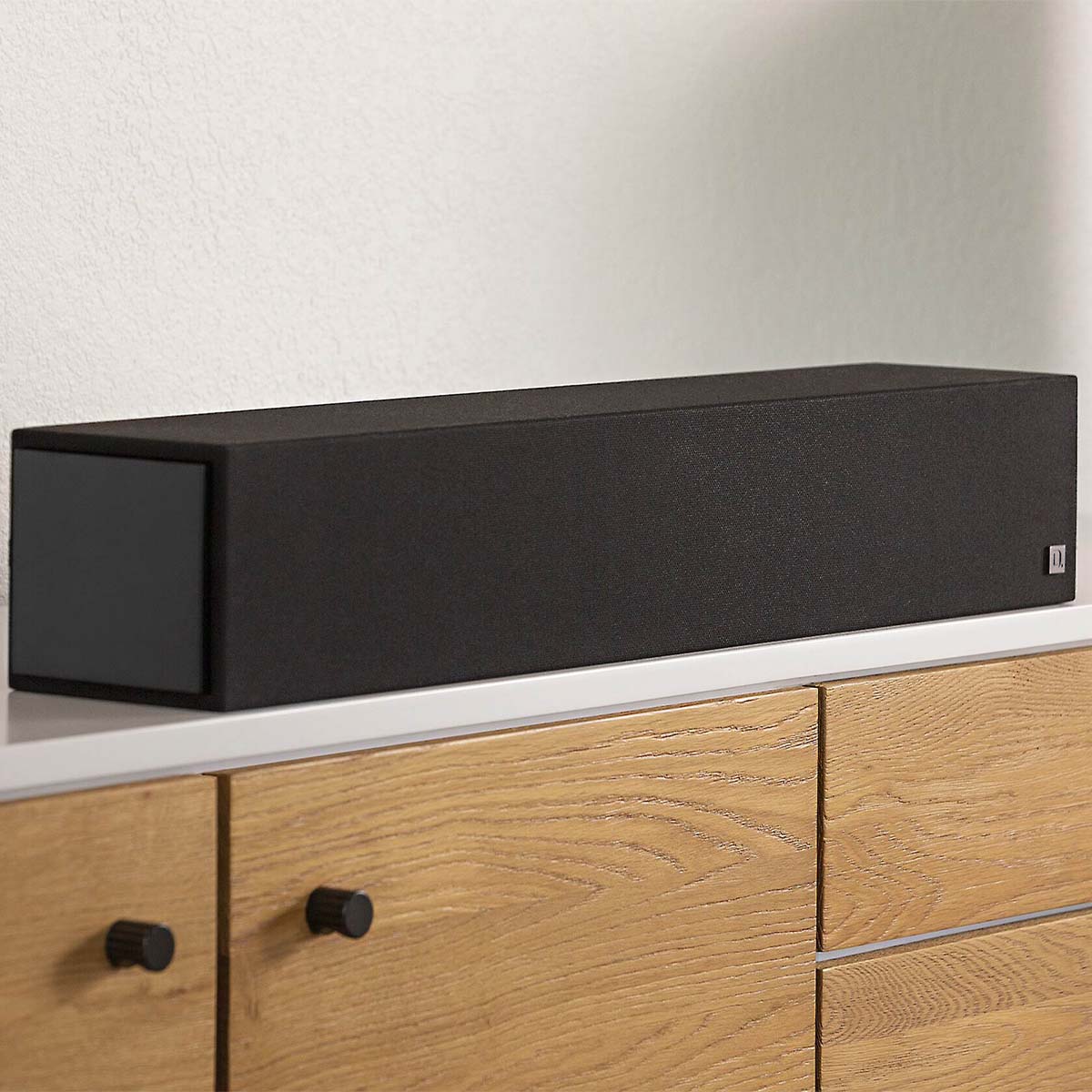 Dymension 20 Center Channel Speaker In Black Front on media cabinet