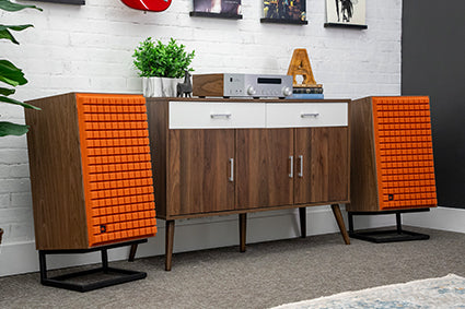 JBL L100 Classic MkII Loudspeaker pair in orange on either side of media cabinet