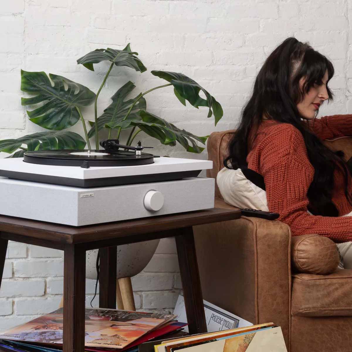 Andover SpinBase 2 Powered Turntable Speaker - white - lifestyle shot of unit on sidetable with turntable on top angled right
