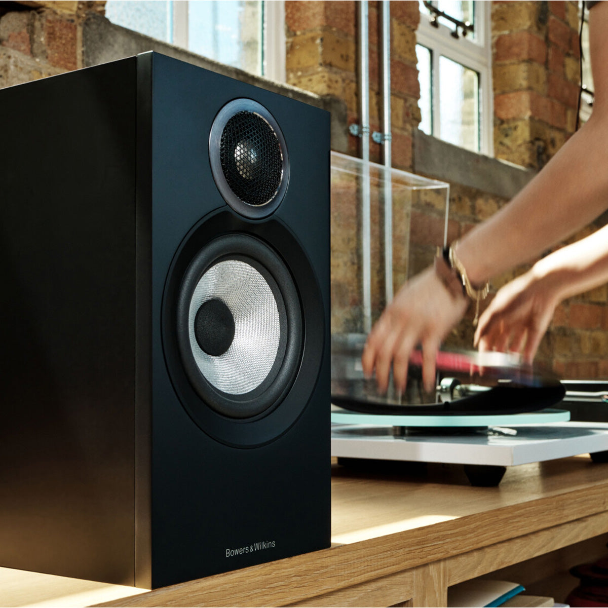 Bowers & Wilkins 607 S3 Bookshelf speaker on table beside a turntable