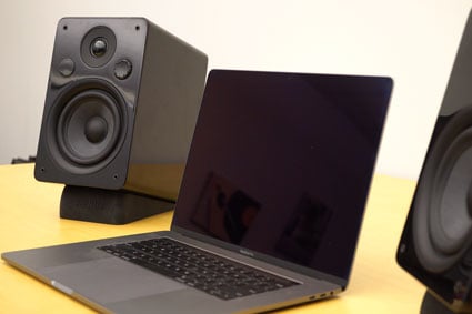 Peachtree M25 speakers on either side of a laptop computer