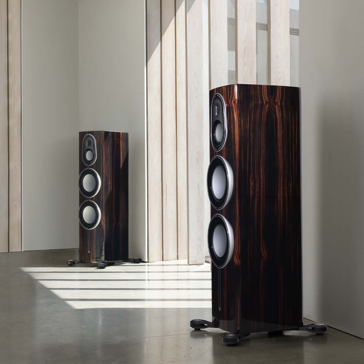 Monitor Audio Platinum 300 3G Floorstanding Loudspeaker - piano ebony pair in room with window in between