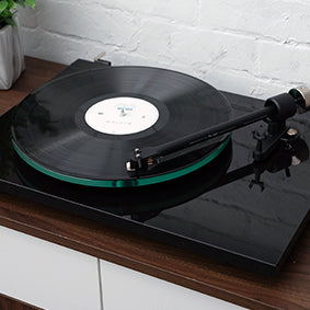 Pro-Ject T2 Turntable in Piano Black on a wooden console table