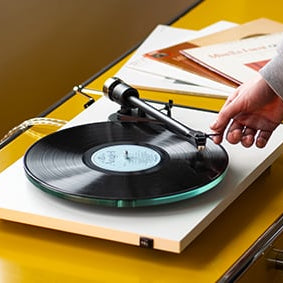 Pro-Ject T2 Turntable in Gloss White on a yellow table