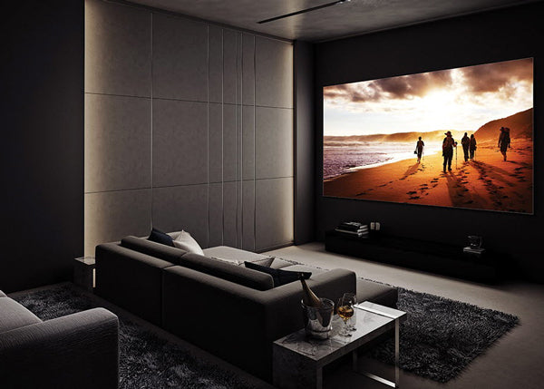 A modern home theater or living room with a large wall-mounted screen.