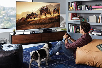 male model sitting on the floor playing video games in front of LED TV
