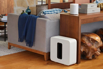 Sonos sub behind couch in living room