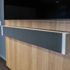 Lyngdorf SB-75 Passive Stereo Speaker Bar - lifesyle photo of unit mounted below TV closeup of right side of unit