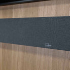 Lyngdorf SB-75 Passive Stereo Speaker Bar - lifesyle photo of unit mounted below TV closeup of Lyngdorf logo