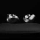 Meze Audio ASTRU Single Dynamic Driver In-Ear Monitors - artistic photo of both earbuds on black background