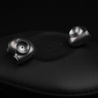 Meze Audio ASTRU Single Dynamic Driver In-Ear Monitors - artistic photo of both earbuds on black background
