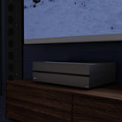 Lyngdorf MXA-8400 Eight-Channel Power Amplifier lifestyle shot of unit on cabinet