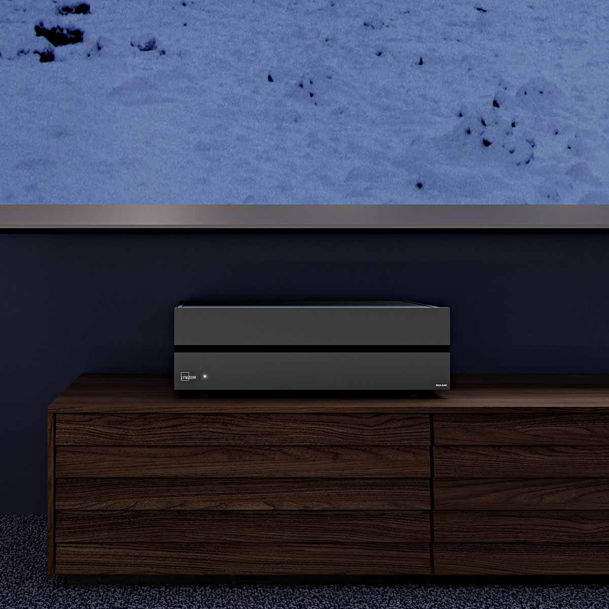 Lyngdorf MXA-8400 Eight-Channel Power Amplifier lifestyle shot of unit on cabinet