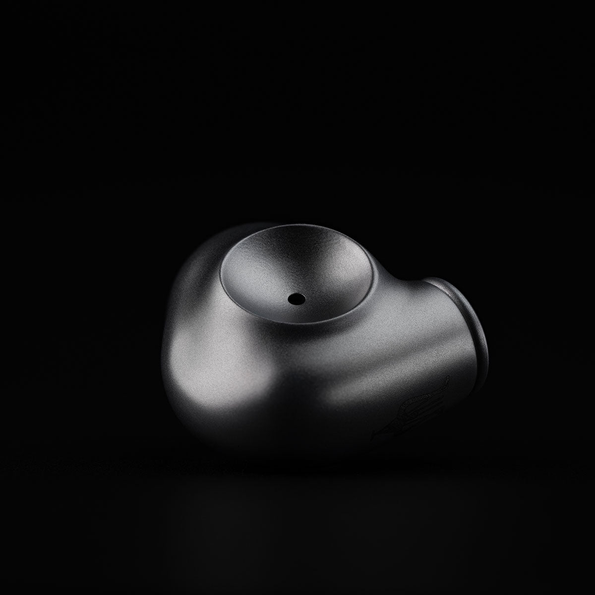 Meze Audio ASTRU Single Dynamic Driver In-Ear Monitors - artistic photo of sinlge earbud on black background