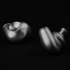 Meze Audio ASTRU Single Dynamic Driver In-Ear Monitors - artistic photo of both earbuds on black background, left earbud in focus