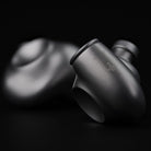 Meze Audio ASTRU Single Dynamic Driver In-Ear Monitors - artistic photo of both earbuds on black background, right earbud in focus showing Meze logo