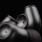 Meze Audio ASTRU Single Dynamic Driver In-Ear Monitors - artistic photo of both earbuds on black background, right earbud in focus showing Meze logo