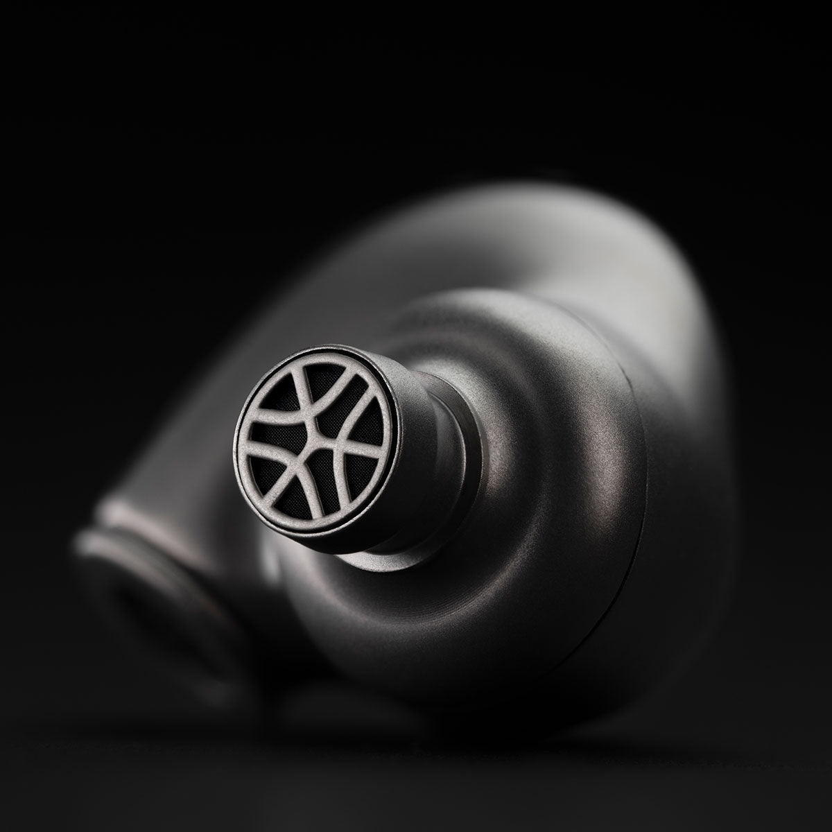 Meze Audio ASTRU Single Dynamic Driver In-Ear Monitors - artistic photo of single earbud on black background