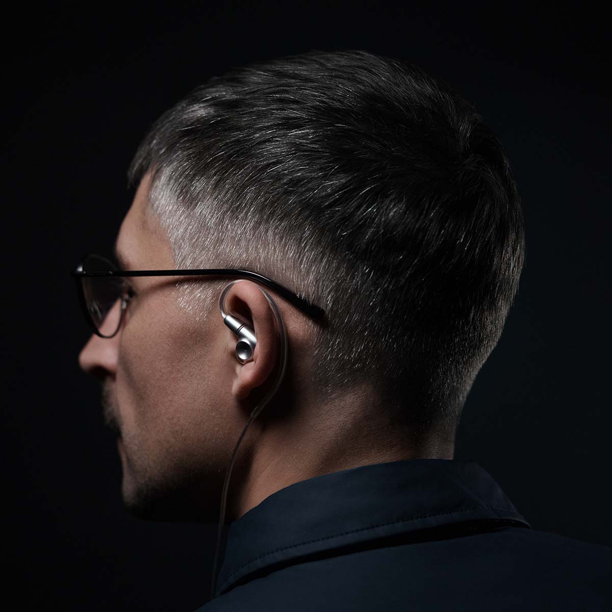 Meze Audio ASTRU Single Dynamic Driver In-Ear Monitors - man with glasses looking left wearing earbud in left ear