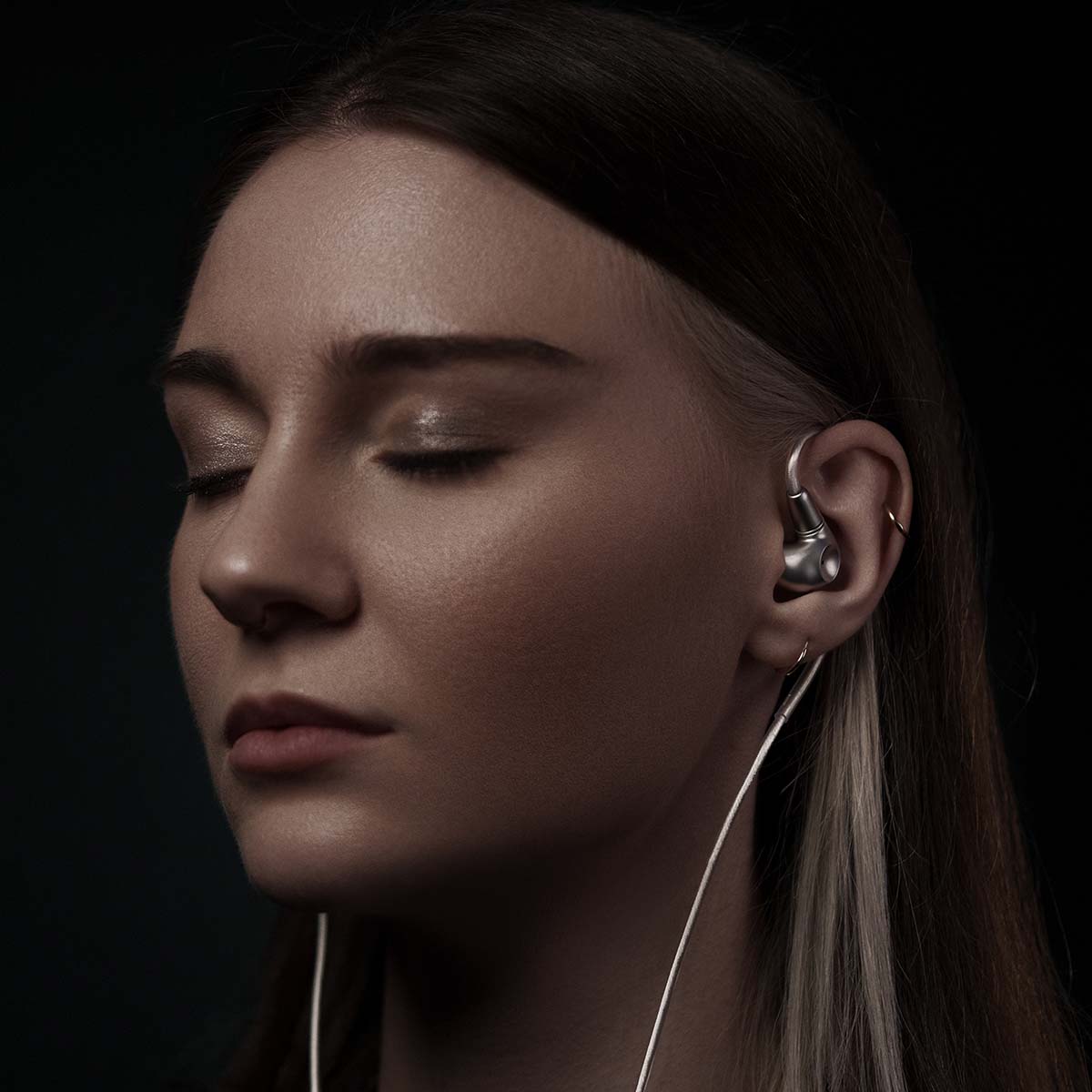 Meze Audio ASTRU Single Dynamic Driver In-Ear Monitors - woman facing left with eyes closed wearing earbuds