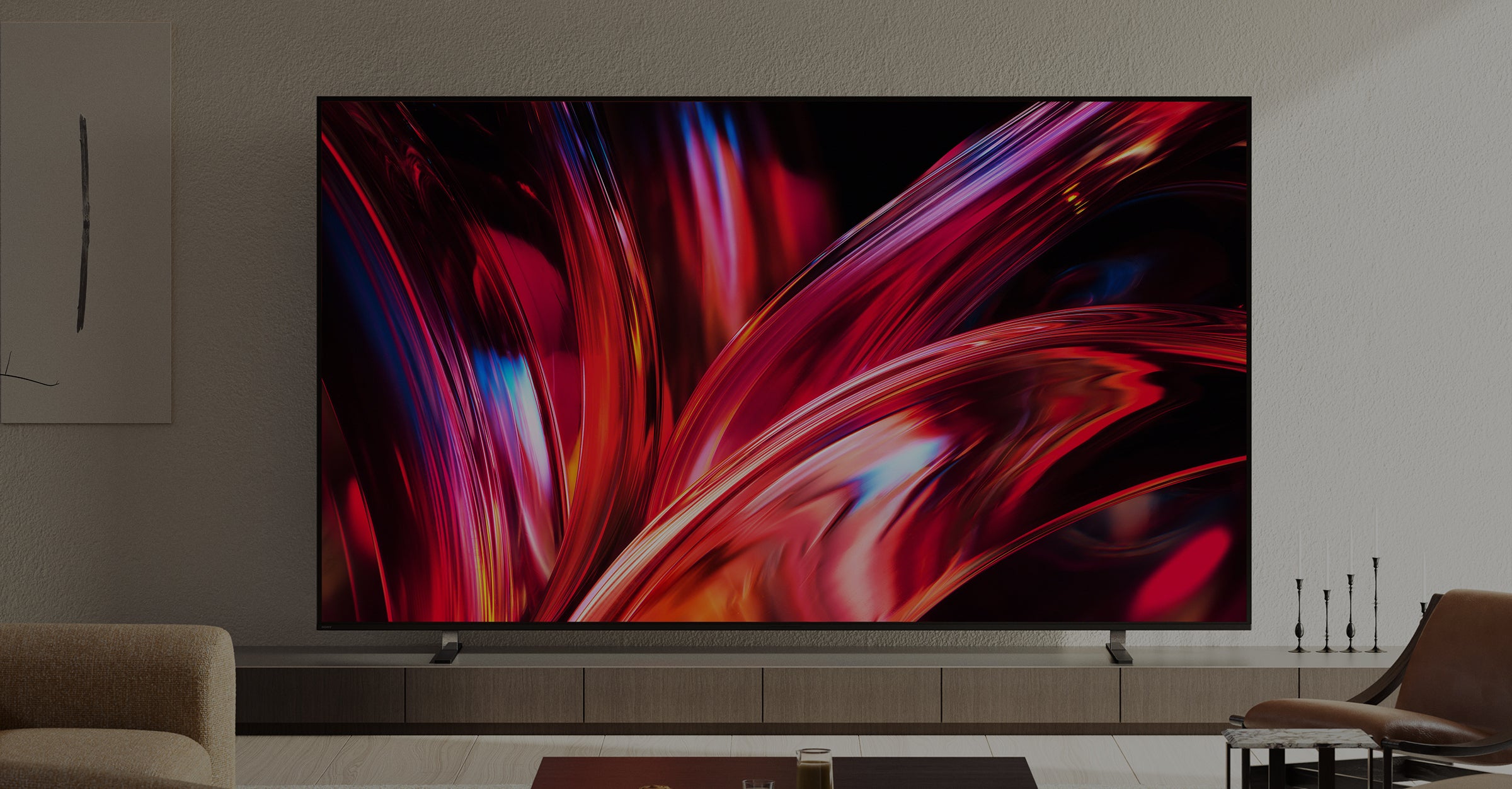 Large flat-screen TV displaying a colorful abstract design in a living room setting.