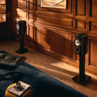 Bowers & Wilkins 805 D5 Bookshelf Loudspeaker - lifestyle photo of pair of Stealth Black speakers on stand without grille facing left