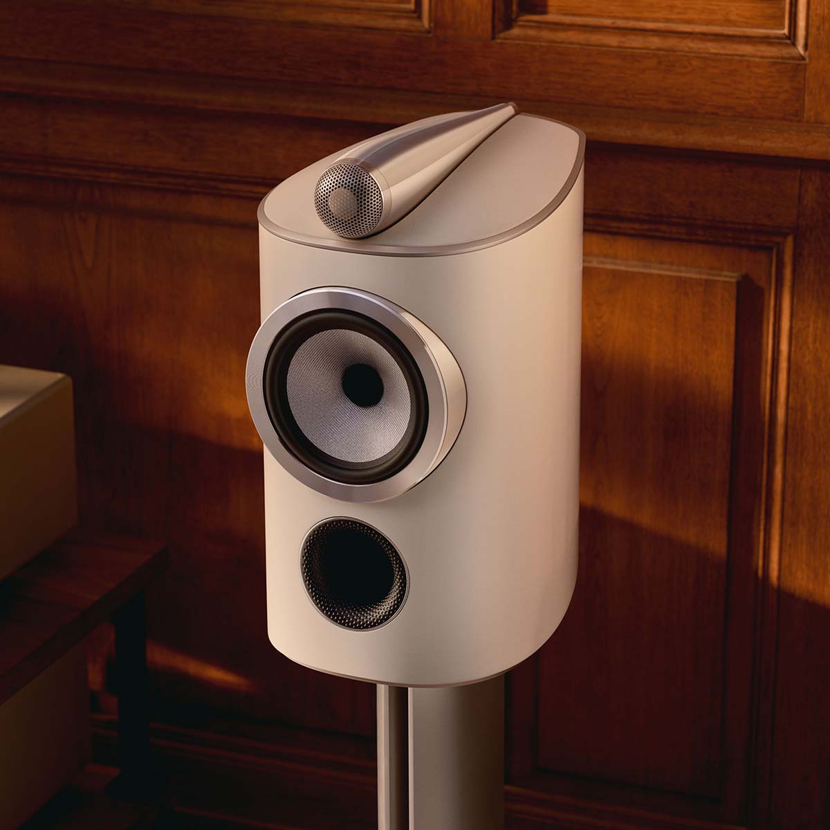 Bowers & Wilkins 805 D5 Bookshelf Loudspeaker - detail lifestyle photo of single Warm White speaker on stand without grille angled left