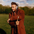Bowers & Wilkins Px8 S2 Wireless Over-Ear Headphones - Lifestyle photo of David Beckham wearing Stone pair