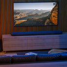 Bluesound Pulse Cinema Multi-Room Streaming Soundbar lifestyle photo of unit on cabinet under TV