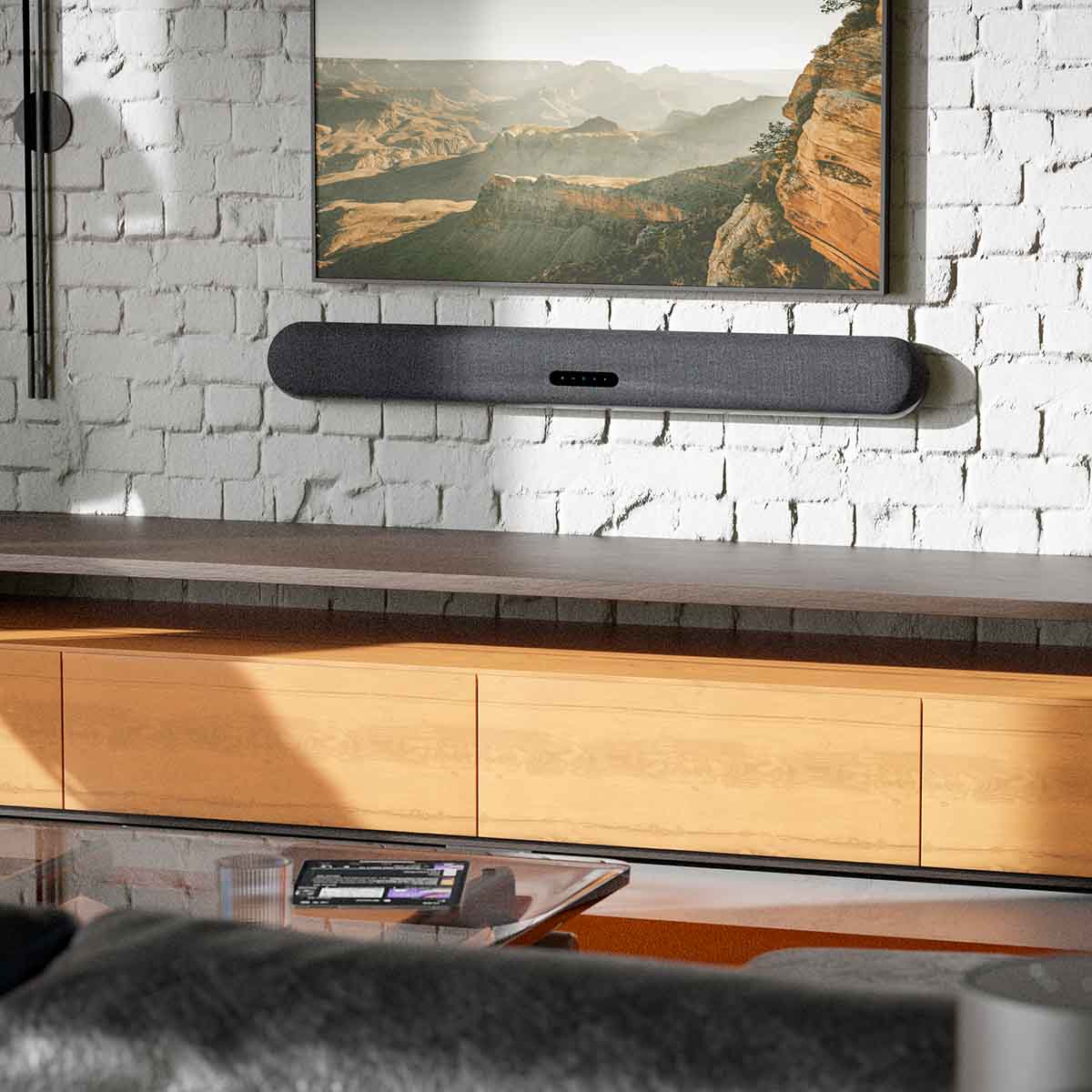 Bluesound Pulse Cinema Multi-Room Streaming Soundbar lifestyle photo of unit wall mounted under TV