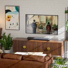 Bluesound Pulse Cinema Mini Multi-Room Streaming Soundbar Black lifestyle photo of unit on cabinet below TV