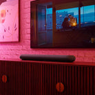 Bluesound Pulse Cinema Mini Multi-Room Streaming Soundbar Black lifestyle photo of unit on cabinet below TV