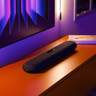 Bluesound Pulse Cinema Mini Multi-Room Streaming Soundbar Black lifestyle photo of unit on cabinet below TV